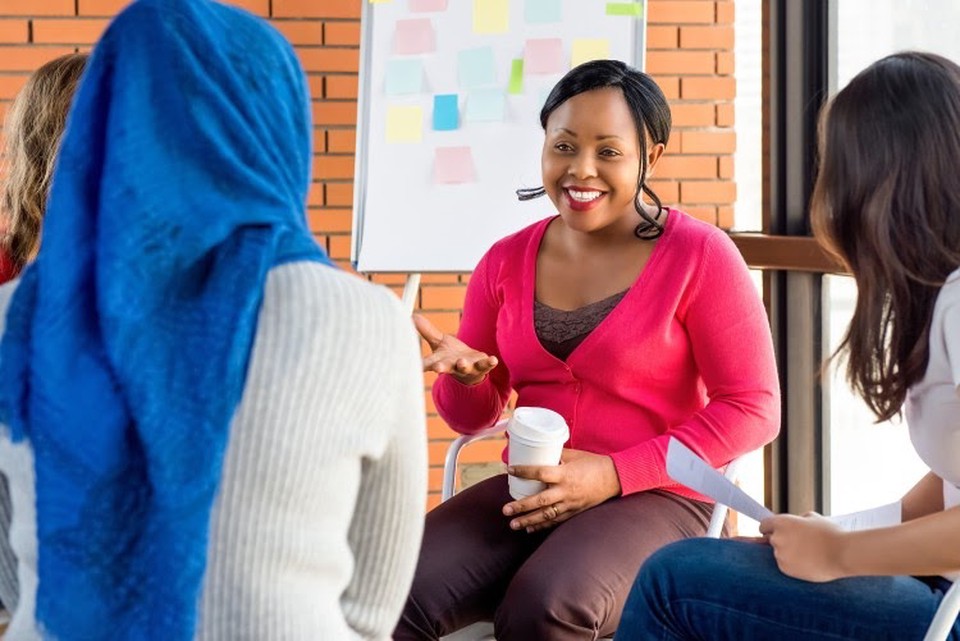 A social worker runs a group therapy session.