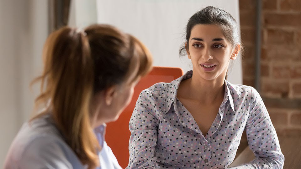 A female coach advising a female student.