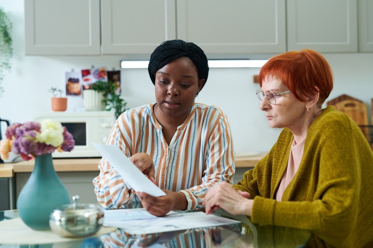 A social worker goes over a document with a client.