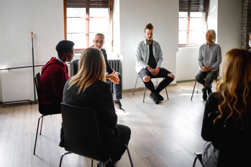 A clinical social worker leads a group therapy session.