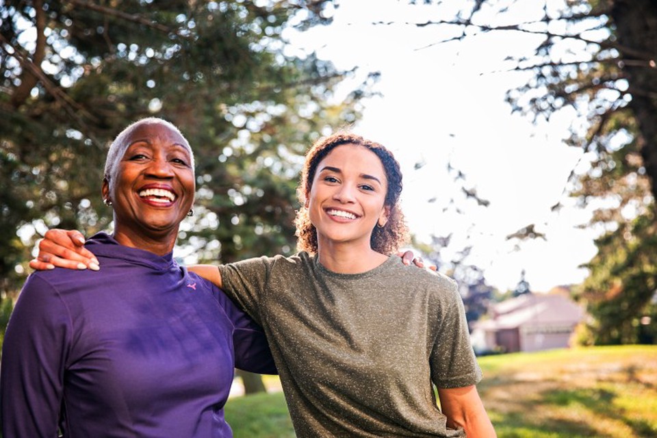 A social worker smiles with an older client.