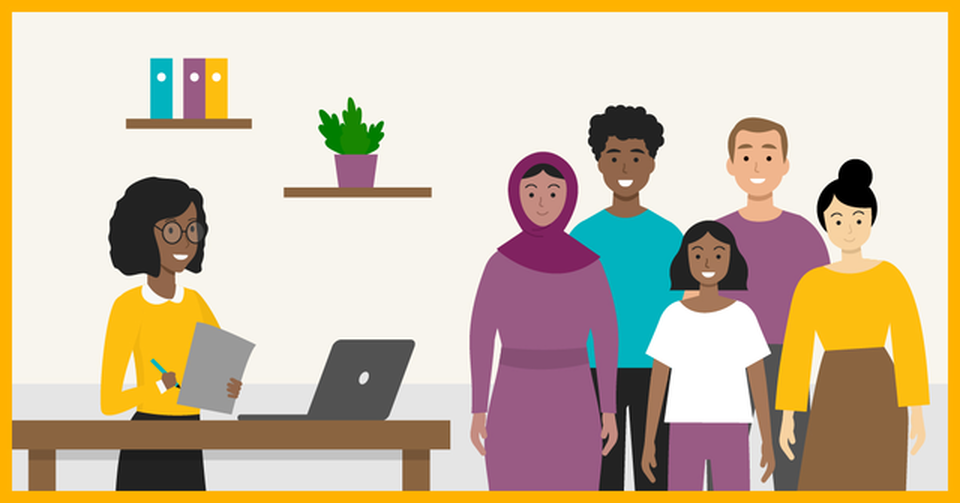 A group of people representing various ethnicities stand next to a smiling social worker.